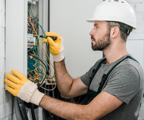 side-view-of-handsome-bearded-electrician-repairin-resize.jpg